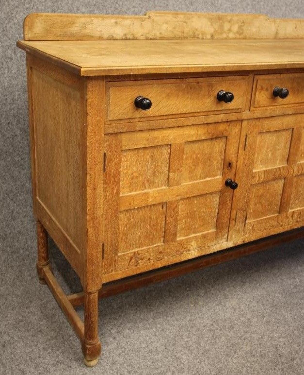 AN ARTS AND CRAFTS STYLE OAK DINING SUITE by Heals of London Image
