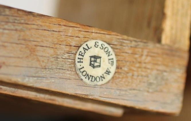 AN ARTS AND CRAFTS STYLE OAK DINING SUITE by Heals of London Image