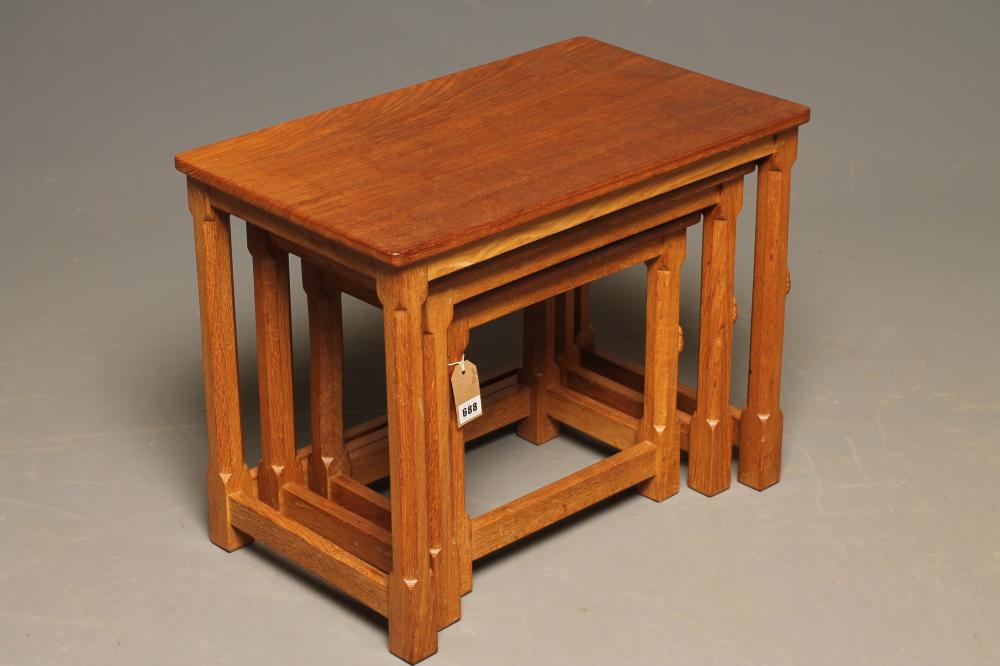 A ROBERT THOMPSON ADZED OAK NEST OF TABLES of rounded oblong form Image