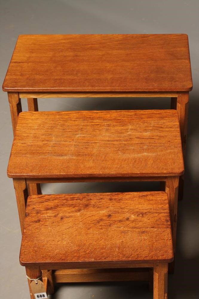 A ROBERT THOMPSON ADZED OAK NEST OF TABLES of rounded oblong form Image