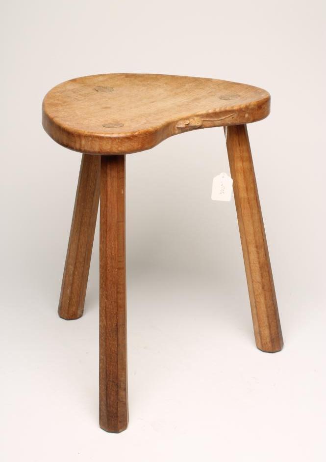 A ROBERT THOMPSON ADZED OAK STOOL of kidney form with carved mouse trademark in relief to seat edge Image