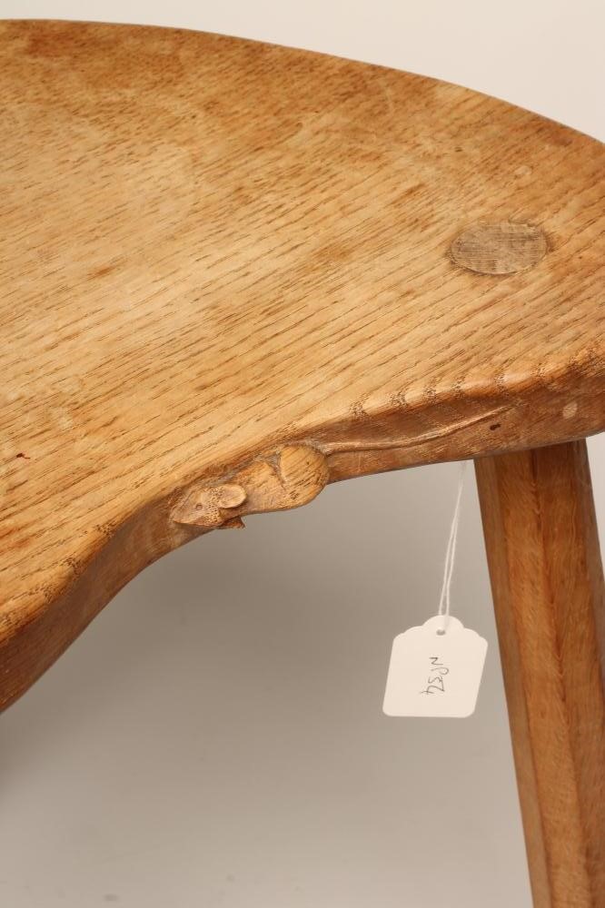 A ROBERT THOMPSON ADZED OAK STOOL of kidney form with carved mouse trademark in relief to seat edge Image