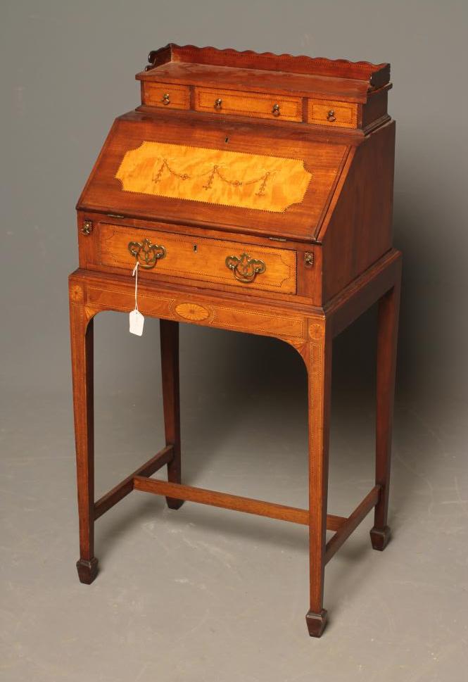 AN EDWARDIAN MAHOGANY BONHEUR DU JOUR with chequer stringing and inlaid paterae Image