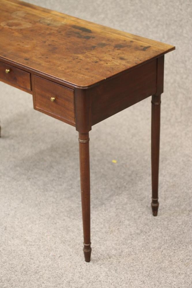 A REGENCY MAHOGANY KNEEHOLE WRITING/DRESSING TABLE of rounded oblong form with reeded edged top Image