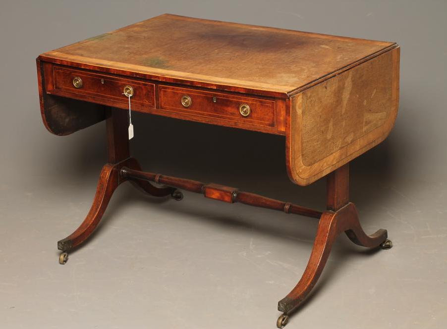 A REGENCY MAHOGANY SOFA TABLE of rounded oblong form with satinwood banding and stringing Image