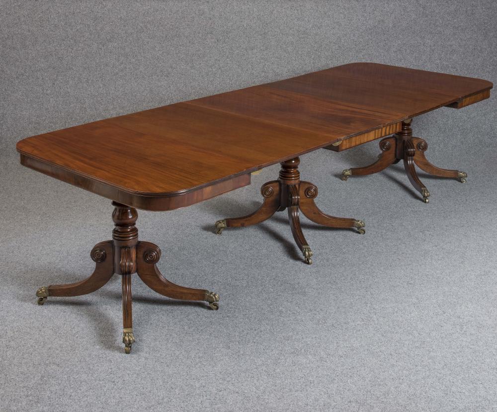 A GEORGIAN MAHOGANY TRIPLE PILLAR DINING TABLE Image