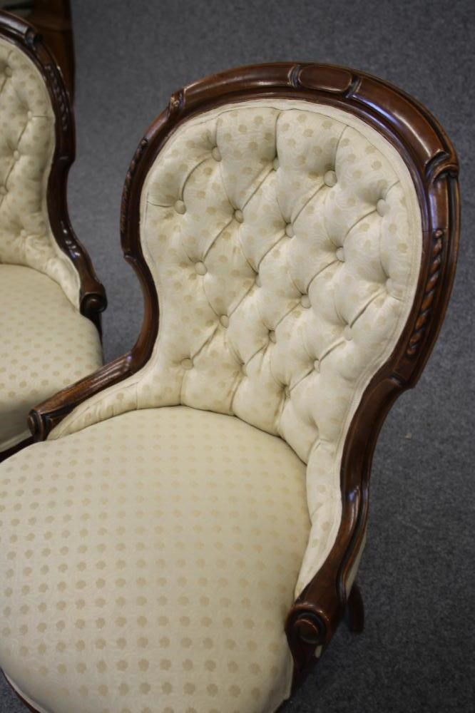 A PAIR OF VICTORIAN WALNUT FRAMED PARLOUR CHAIRS of spoonback form button upholstered in a cream Image
