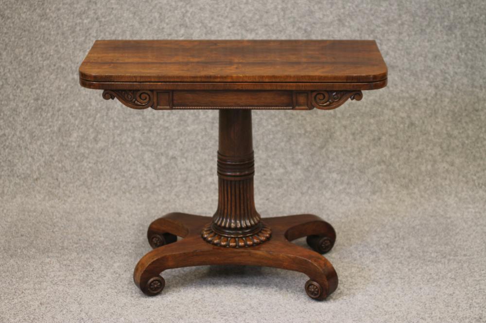 A REGENCY ROSEWOOD FOLDING CARD TABLE of rounded oblong form Image
