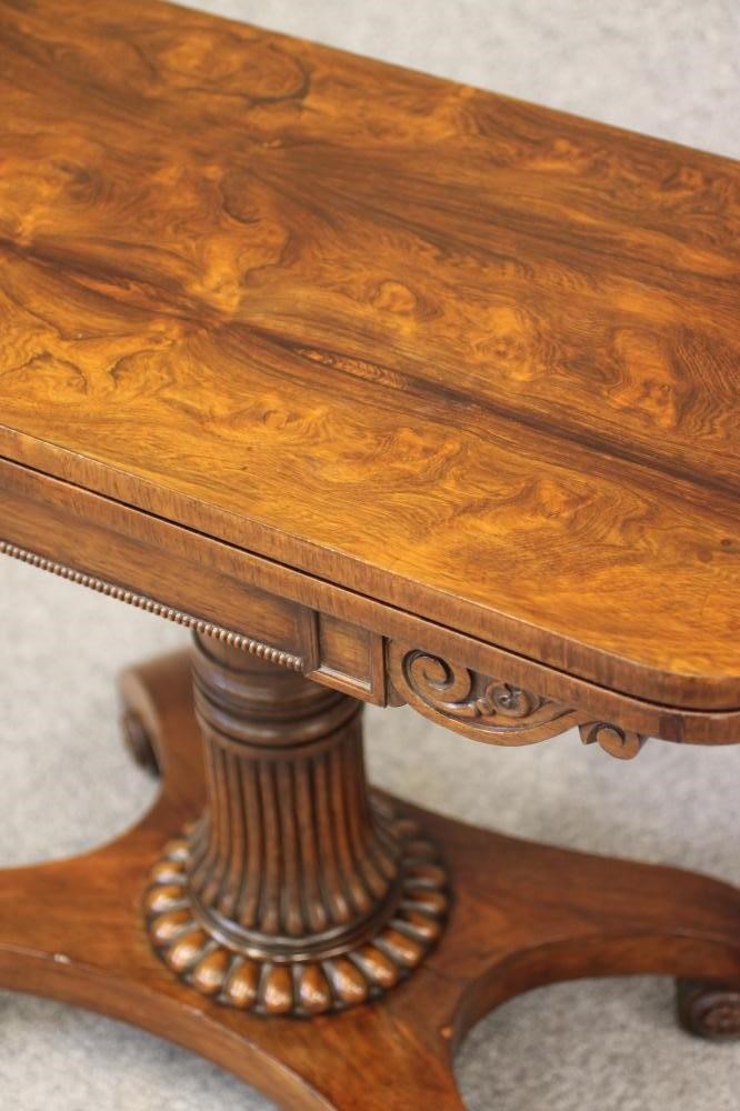 A REGENCY ROSEWOOD FOLDING CARD TABLE of rounded oblong form Image