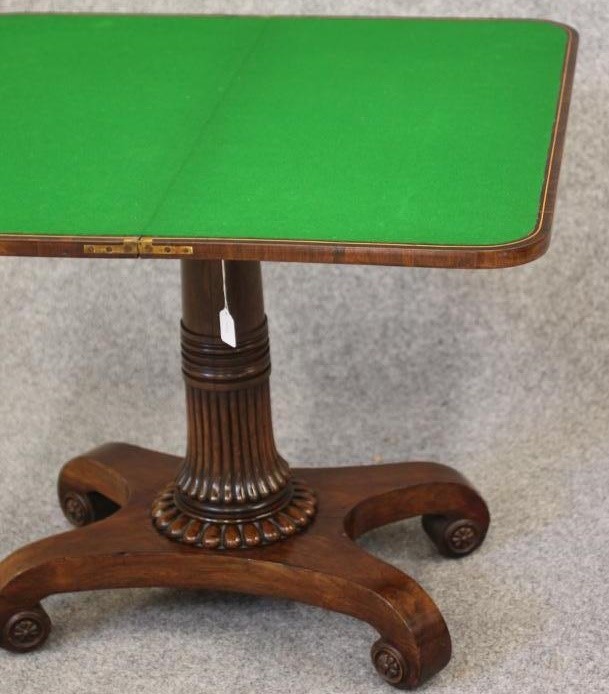 A REGENCY ROSEWOOD FOLDING CARD TABLE of rounded oblong form Image
