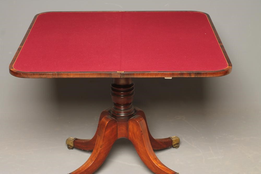 A REGENCY MAHOGANY FOLDING CARD TABLE of rounded oblong form with rosewood banding Image