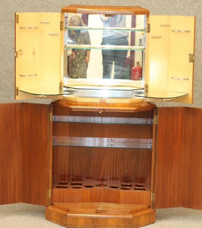 AN ART DECO BURR WALNUT COCKTAIL CABINET of oblong stepped faceted form Image