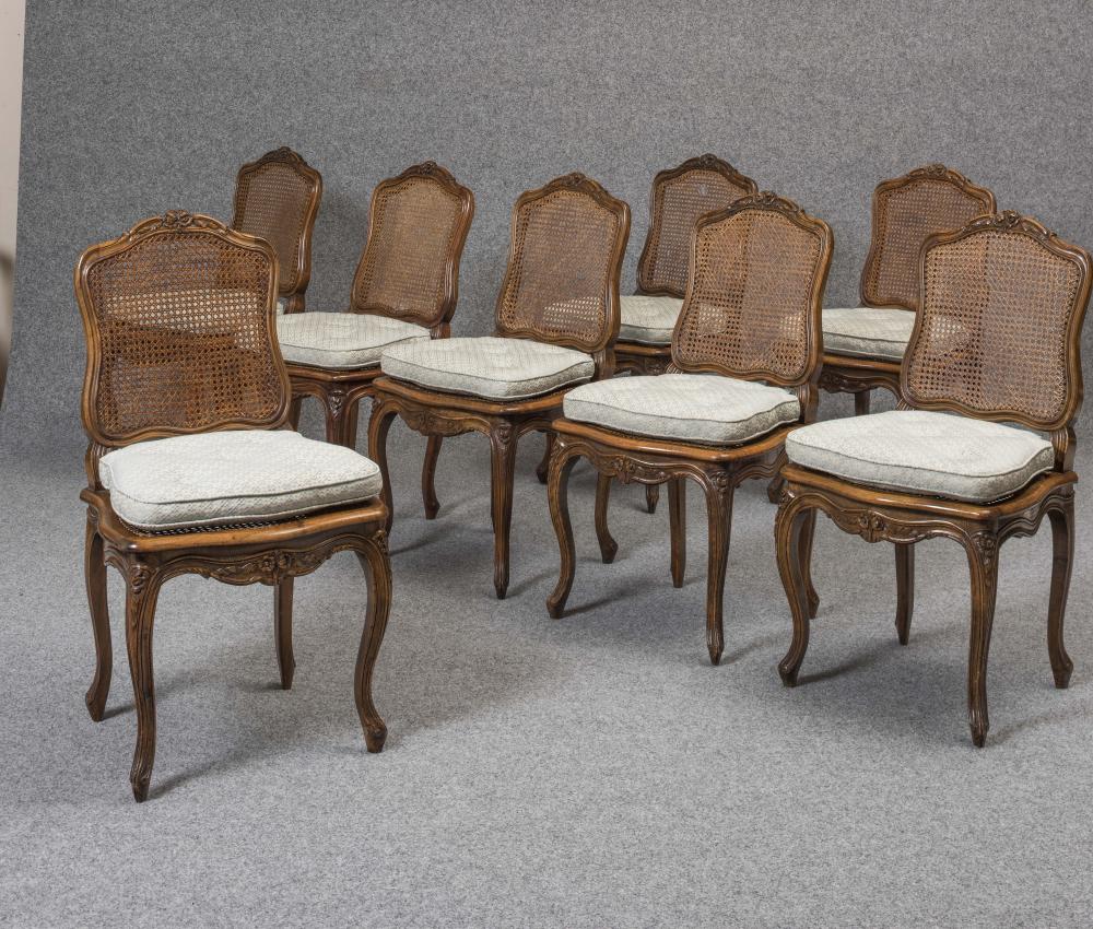 A SET OF EIGHT LOUIS XV STYLE CARVED WALNUT DINING CHAIRS Image
