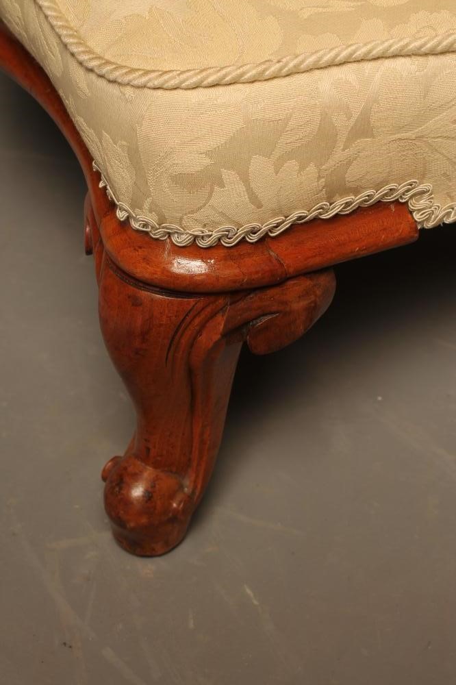 A VICTORIAN WALNUT FRAMED NURSING CHAIR button upholstered in an ivory floral weave Image