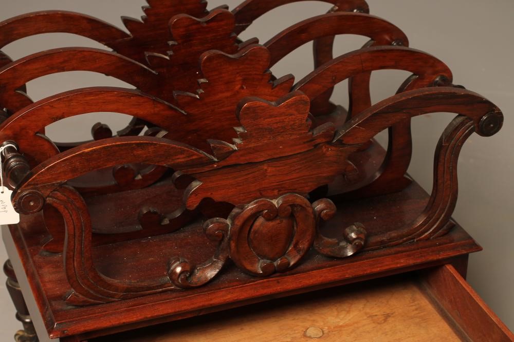 AN EARLY VICTORIAN ROSEWOOD CANTERBURY of oblong form applied with roundels Image