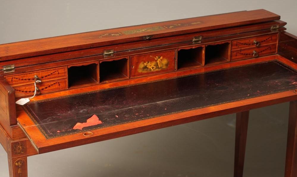 A LADY'S MAHOGANY DESK of oblong form painted with floral swags and musical trophies and with Image