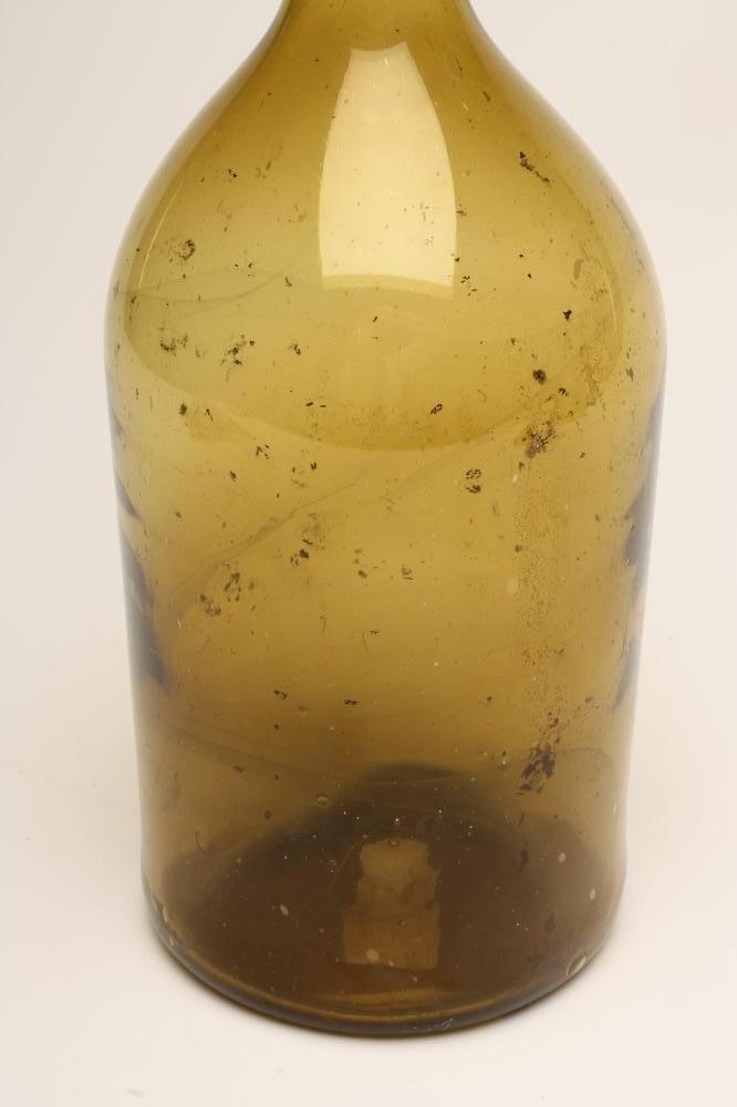 A LARGE GREEN GLASS BOTTLE Image
