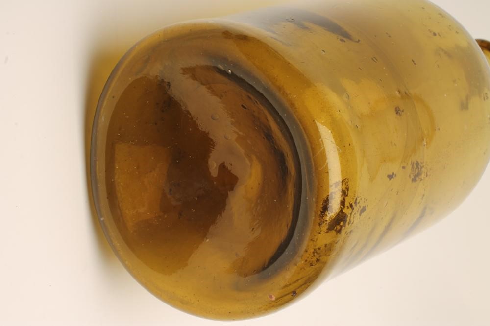 A LARGE GREEN GLASS BOTTLE Image