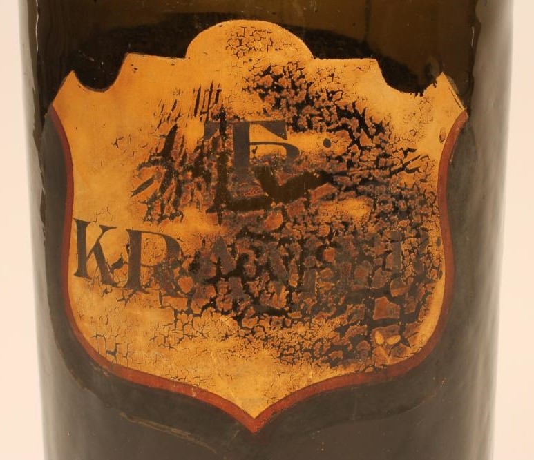 A DARK GREEN GLASS APOTHECARY BOTTLE Image