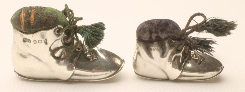 TWO GRADUATED EDWARDIAN SILVER NOVELTY BOOT PIN CUSHIONS Image