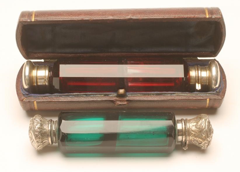 A VICTORIAN RUBY GLASS DOUBLE ENDED SCENT BOTTLE of panelled cylindrical form with one hinged and Image