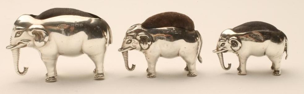 THREE GRADUATED SILVER NOVELTY ELEPHANT PIN CUSHIONS Image