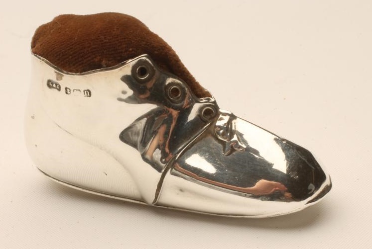 A SILVER NOVELTY BOOT PIN CUSHION Image