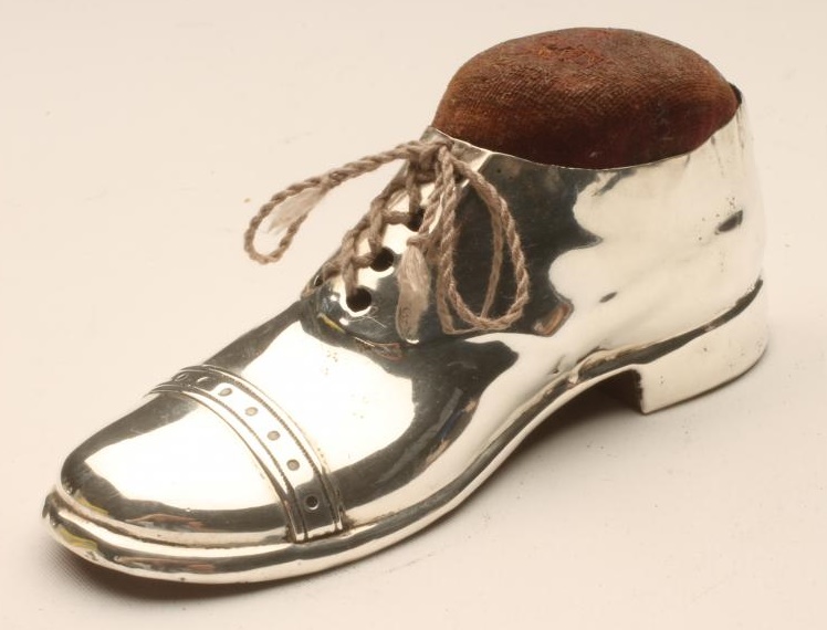 A LARGE SILVER NOVELTY BOOT PIN CUSHION Image
