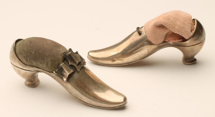 A COMPOSITE PAIR OF EDWARDIAN SILVER NOVELTY COURT SHOE PIN CUSHIONS Image