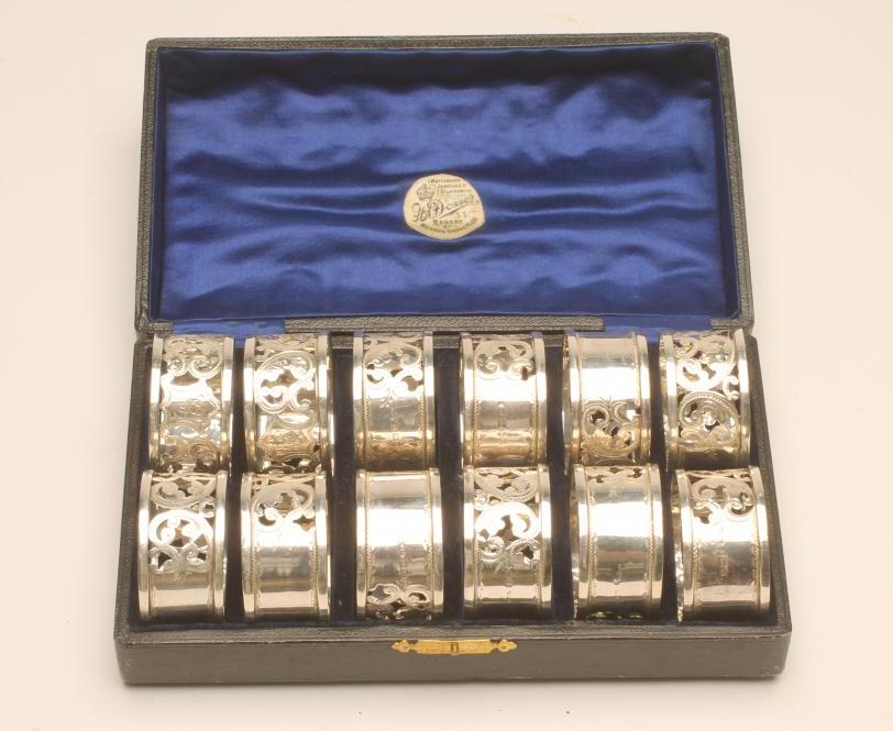 A SET OF TWELVE SILVER NAPKIN RINGS Image