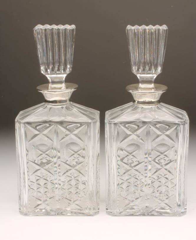 A PAIR OF ART DECO STYLE SILVER MOUNTED CLEAR GLASS DECANTERS Image