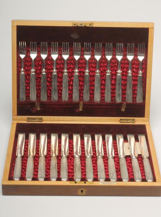 A SET OF TWELVE PAIRS OF VICTORIAN SILVER DESSERT KNIVES AND FORKS Image