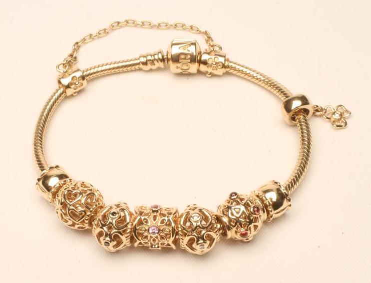 A PANDORA 14CT GOLD BRACELET Image