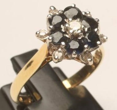A SAPPHIRE AND DIAMOND CLUSTER RING Image