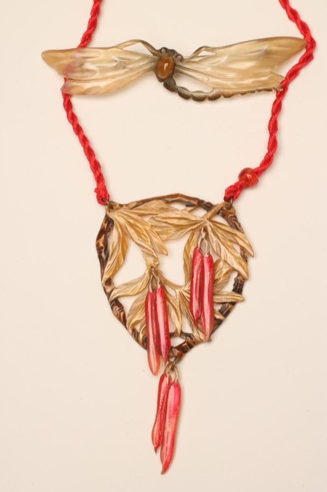 AN ART NOUVEAU PRESSED HORN DRAGONFLY BROOCH Image