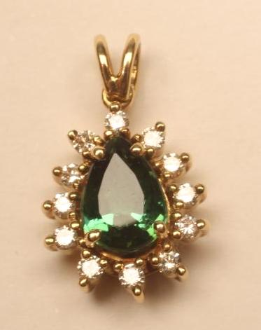 A PENDANT to match the previous lot with tear shaped tourmaline on a plain open bale (Est. plus 18% Image