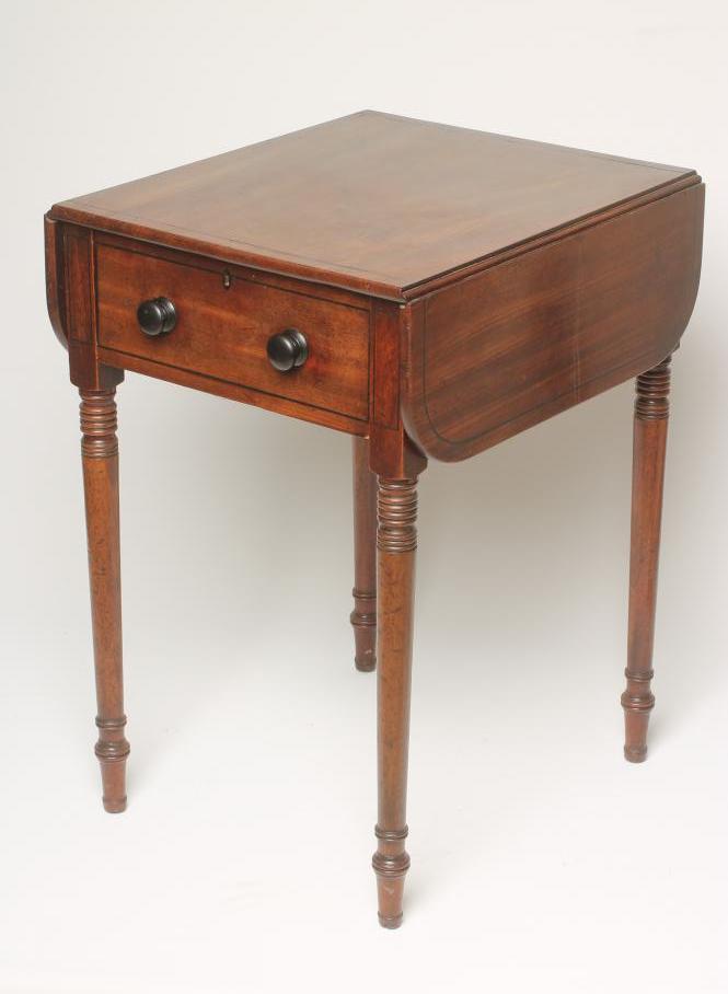 A REGENCY MAHOGANY WORK TABLE of rounded oblong form with ebony stringing Image