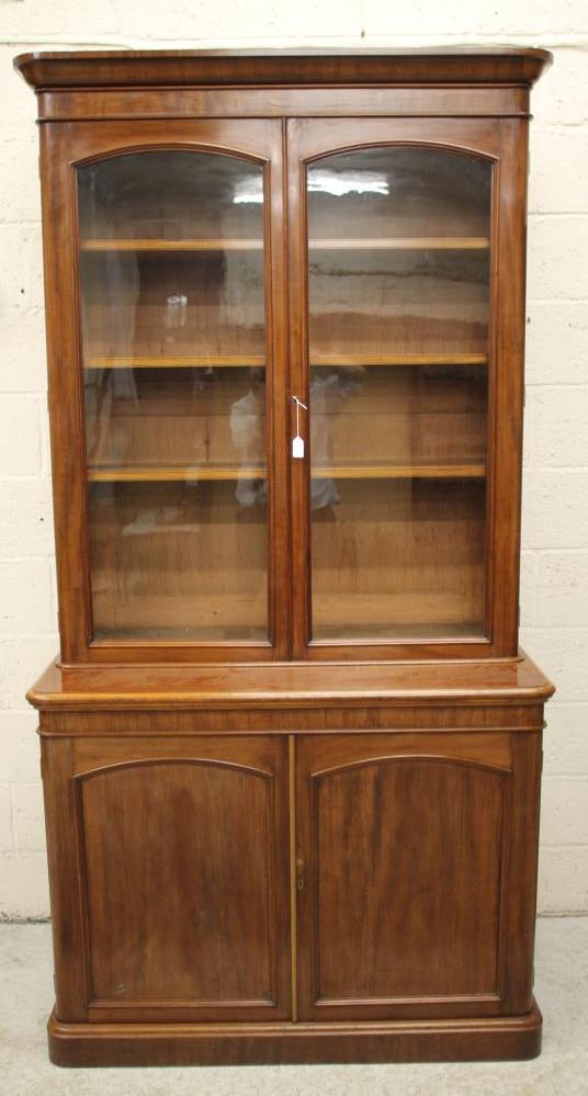 A VICTORIAN MAHOGANY TWO STAGE BOOKCASE of rounded oblong form Image