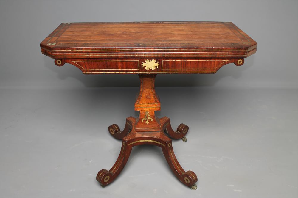 A REGENCY ROSEWOOD AND BRASS INLAID FOLDING CARD TABLE of canted oblong form Image