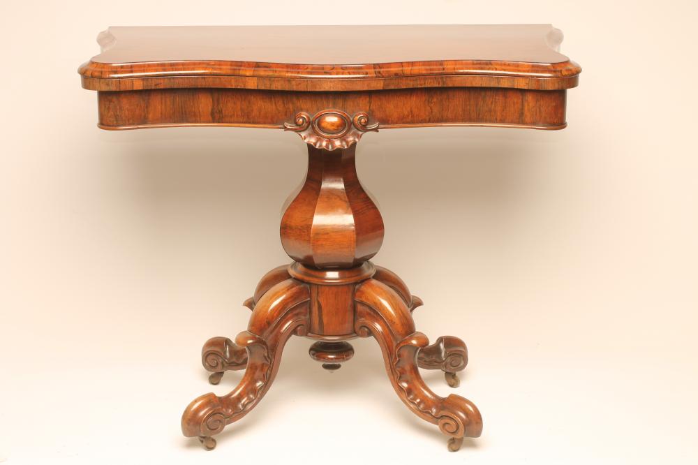 A VICTORIAN ROSEWOOD FOLDING CARD TABLE of serpentine oblong form Image