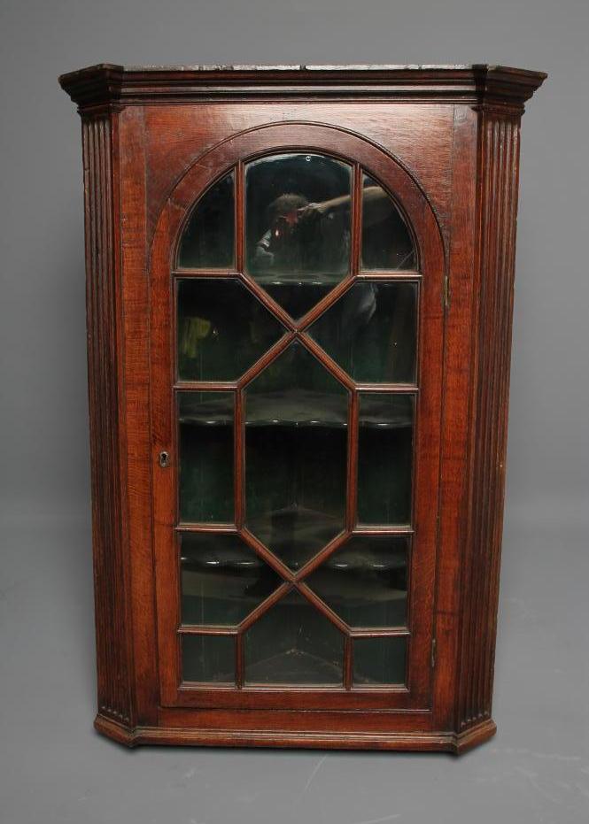 A GEORGIAN OAK CORNER CUPBOARD Image
