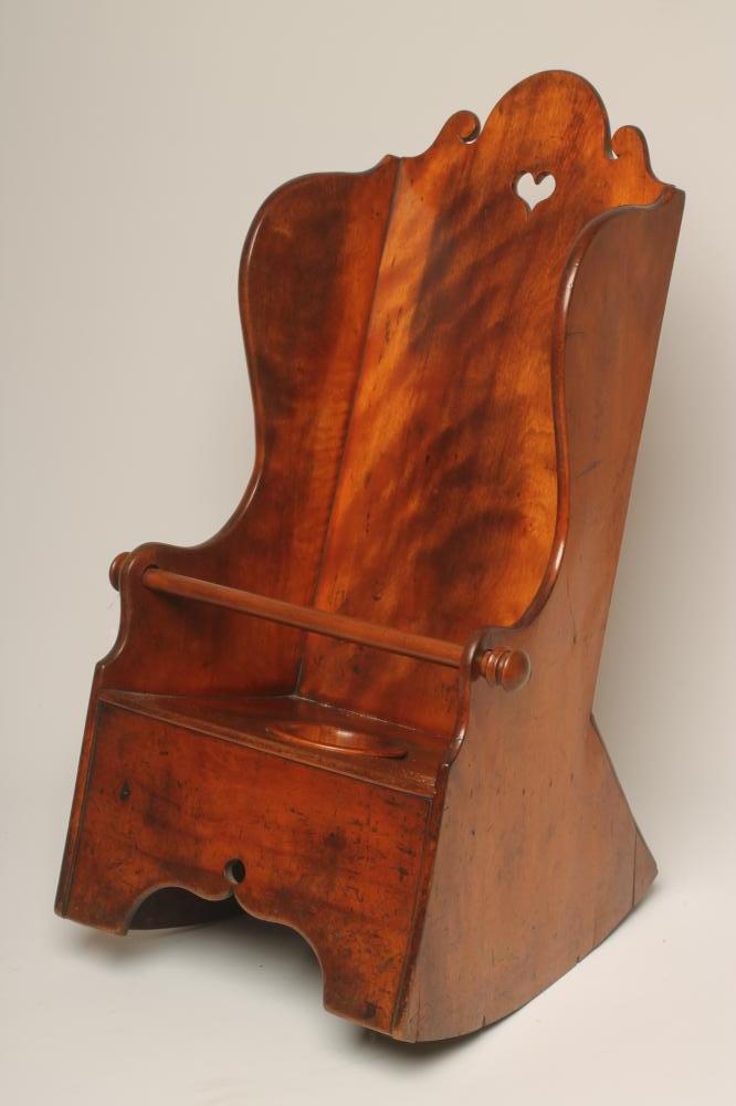 A CHILD'S CHERRY WOOD WING ROCKING CHAIR Image