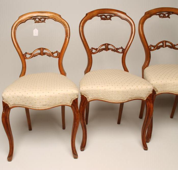 A SET OF SIX VICTORIAN WALNUT DINING CHAIRS of open balloon back form upholstered in an ivory weave Image