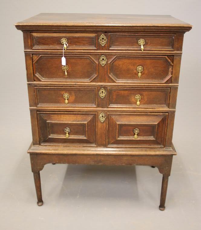 AN OAK GEOMETRIC MOULDED CHEST ON STAND Image