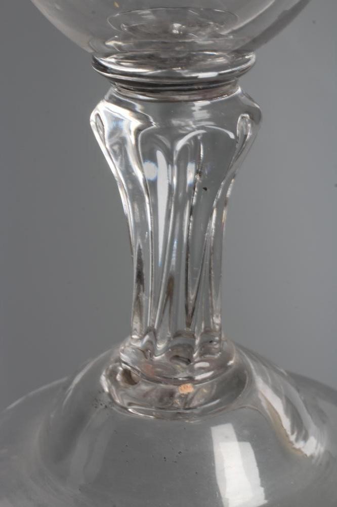 A GLASS GOBLET, late 18th century, the rounded bowl on a wrythen moulded flared cylindrical stem and Image
