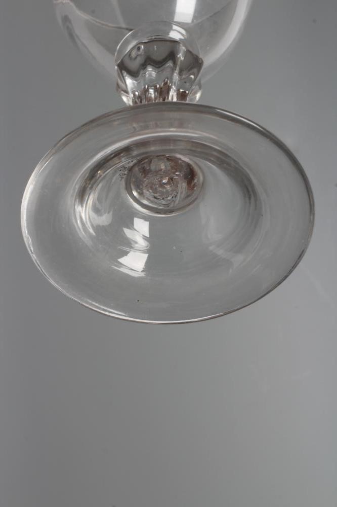 A GLASS GOBLET, late 18th century, the rounded bowl on a wrythen moulded flared cylindrical stem and Image