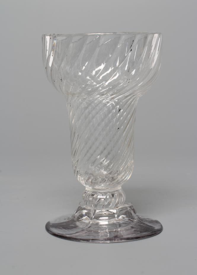 A JELLY GLASS, mid 18th century, the wrythen moulded double ogee bowl on a teared knop and lobed Image