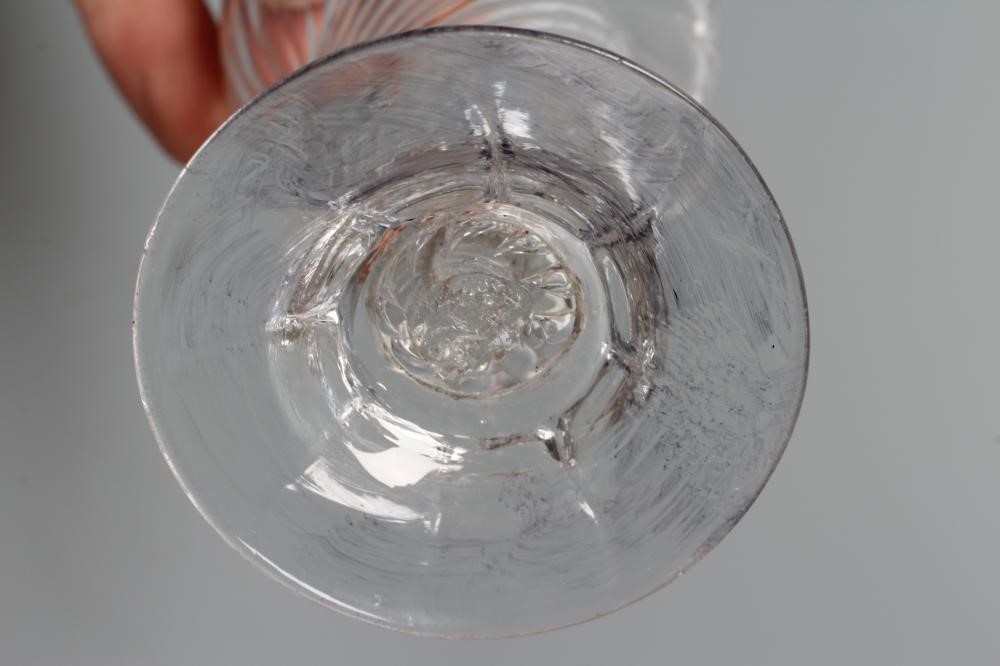 A JELLY GLASS, mid 18th century, the wrythen moulded double ogee bowl on a teared knop and lobed Image