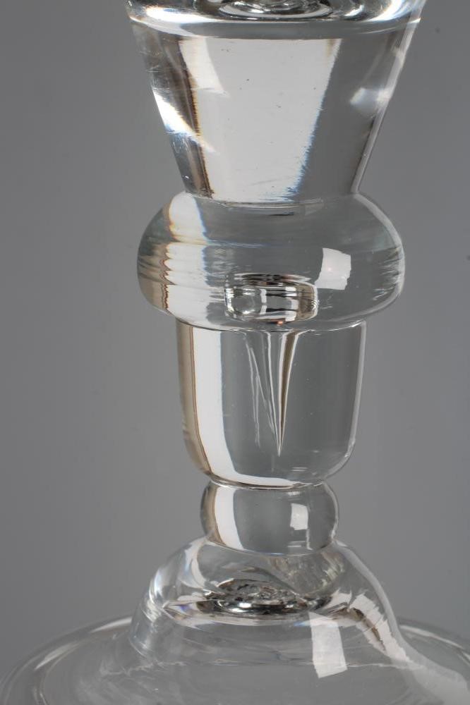 A GLASS GOBLET, early 18th century, the rounded funnel bowl issuing from an acorn knopped stem Image