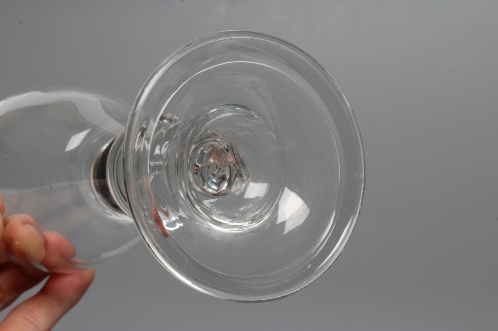 A GLASS GOBLET, early 18th century, the rounded funnel bowl issuing from an acorn knopped stem Image